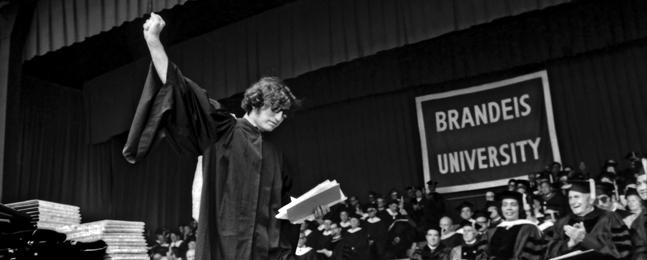 1969 valedictorian Justin Simon raises his fist after delivering commencement speech 